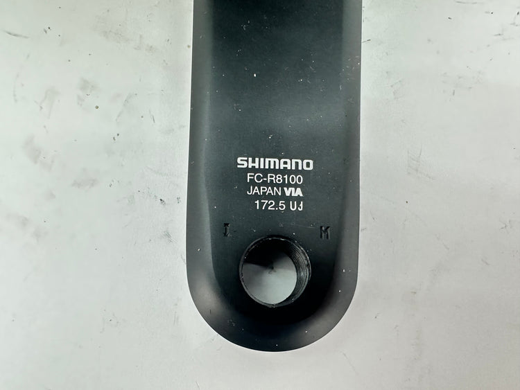 Shimano FC-R8100 component on a gray background