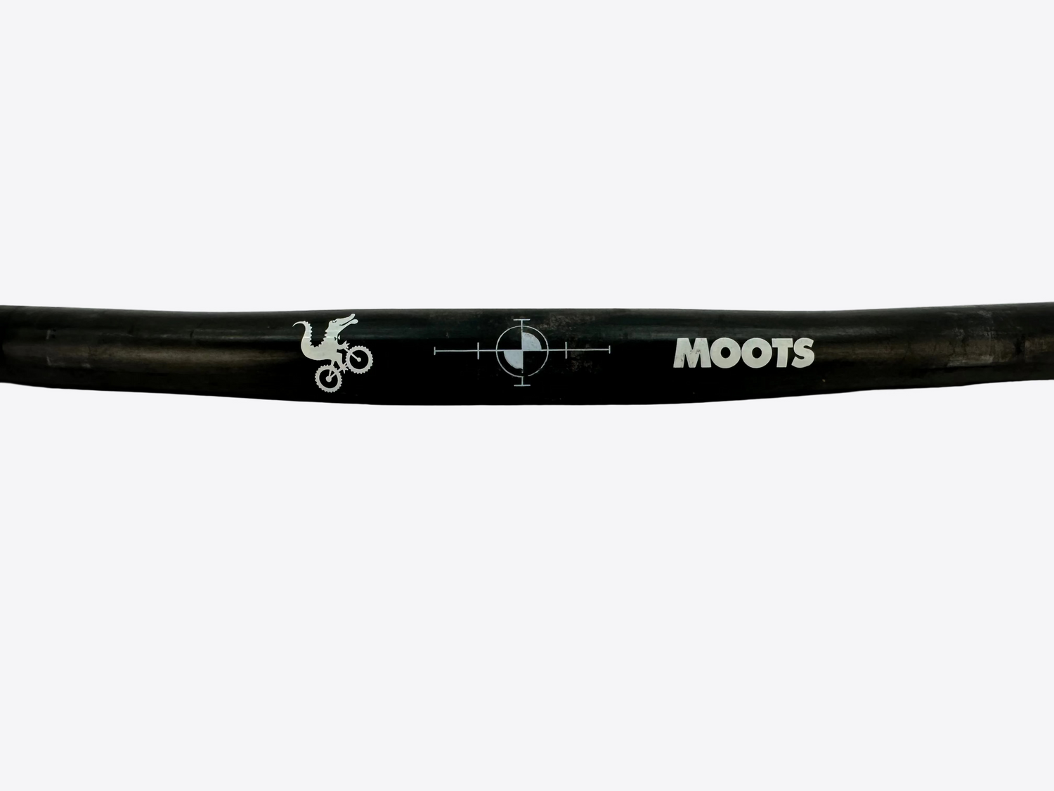 Black bicycle handlebar with 'MOOTS' branding on a light gray background