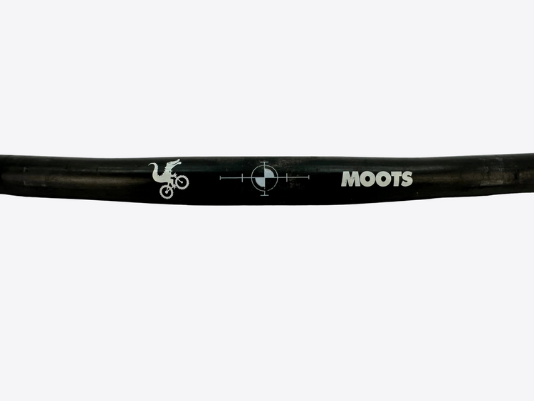 Black bicycle handlebar with 'MOOTS' branding on a light gray background