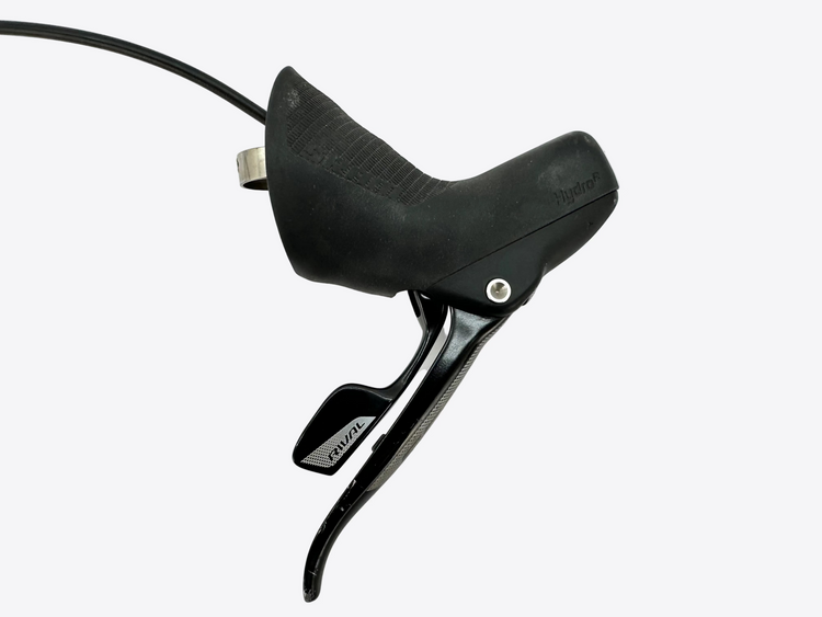Close-up of a black bicycle brake lever on a light gray background