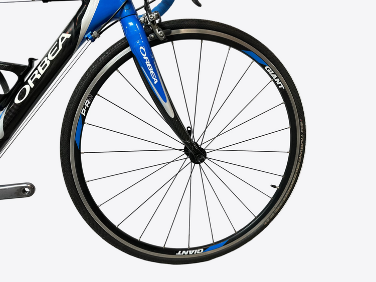 Close-up of a bicycle wheel with 'Orbea' and 'Giant' branding on a white background