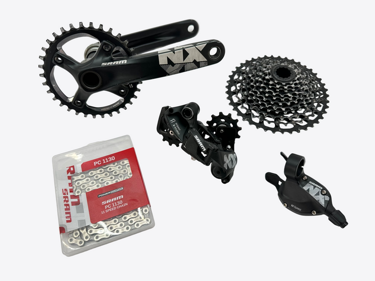 Bicycle components including a chain, gears, and derailleur on a white background