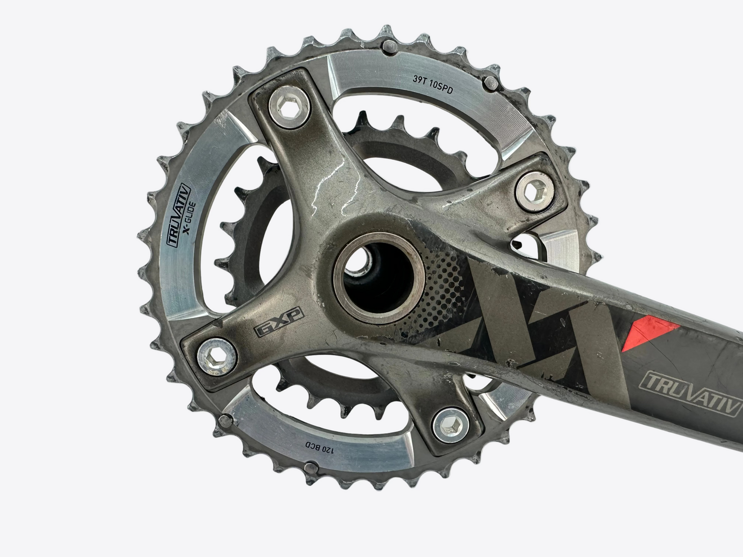 Close-up of a bicycle crankset with sprockets on a light gray background