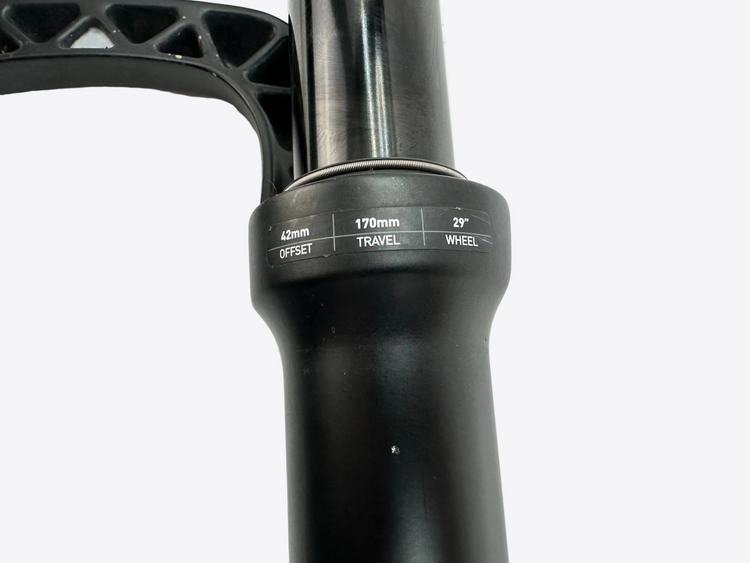 Close-up of a black bicycle fork with specifications on a white background