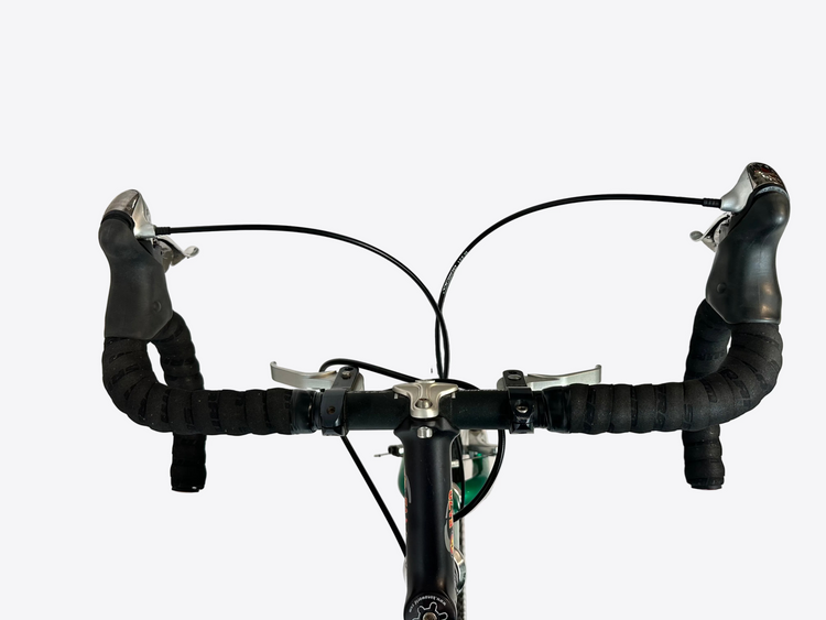 Close-up of a bicycle handlebar with black grips on a white background