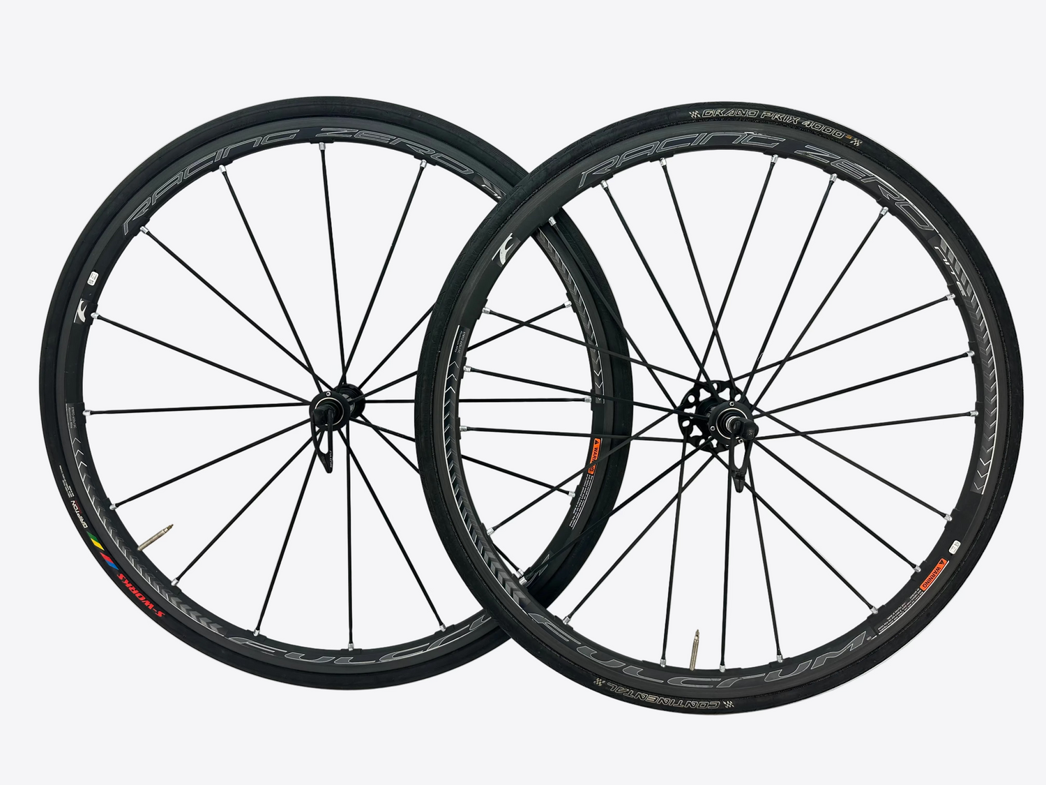 Two bicycle wheels on a white background