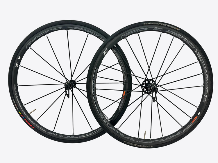 Two bicycle wheels on a white background