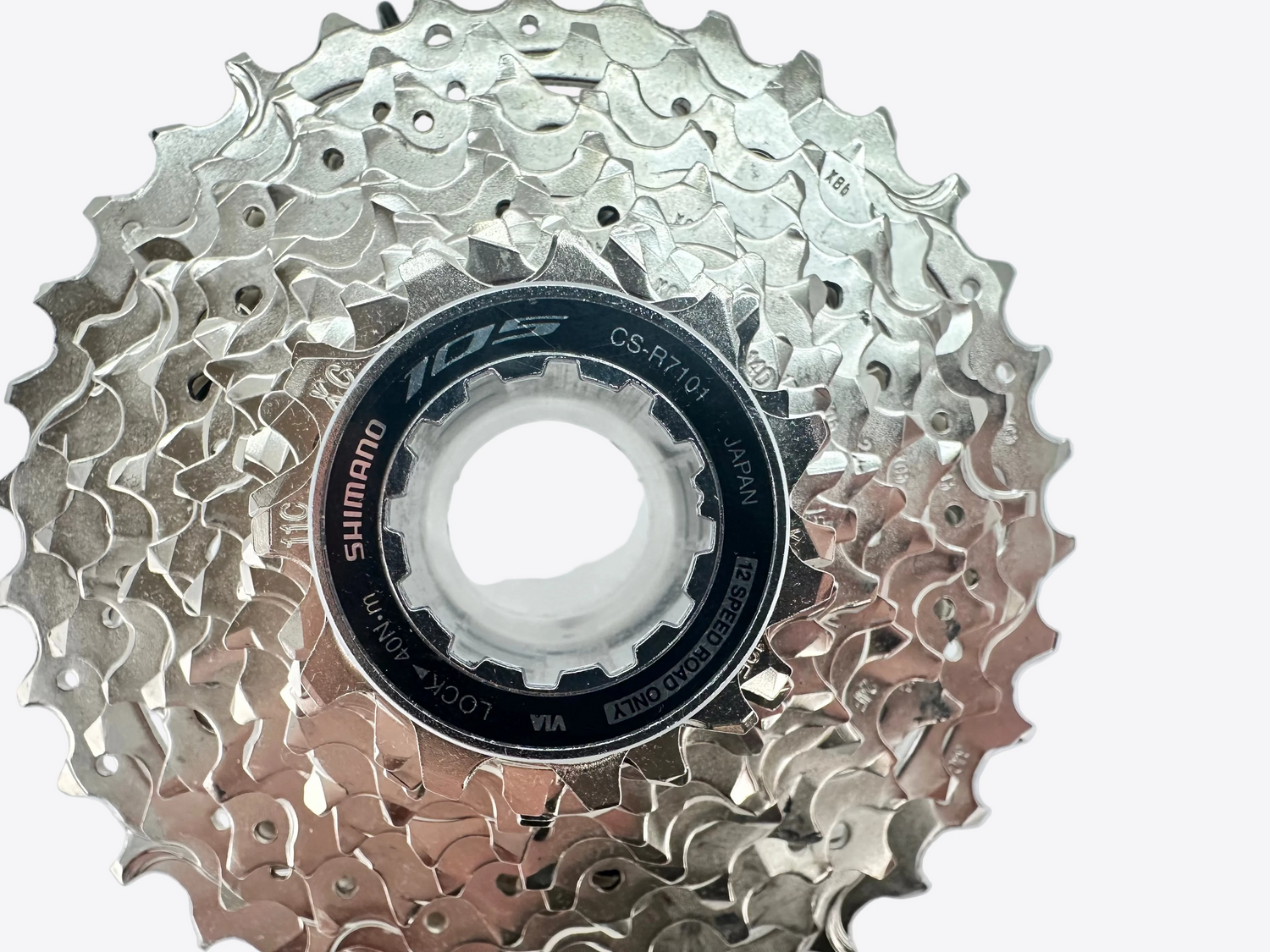 Bicycle gear cassette with Shimano logo on a light gray background