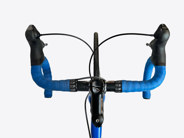 Bicycle handlebar with blue grips on a light gray background