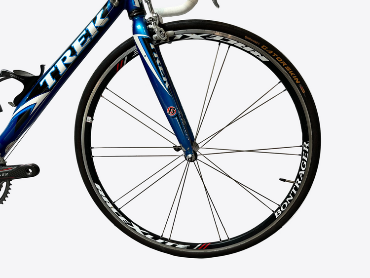 Blue bicycle wheel with 'Trek' branding on a white background