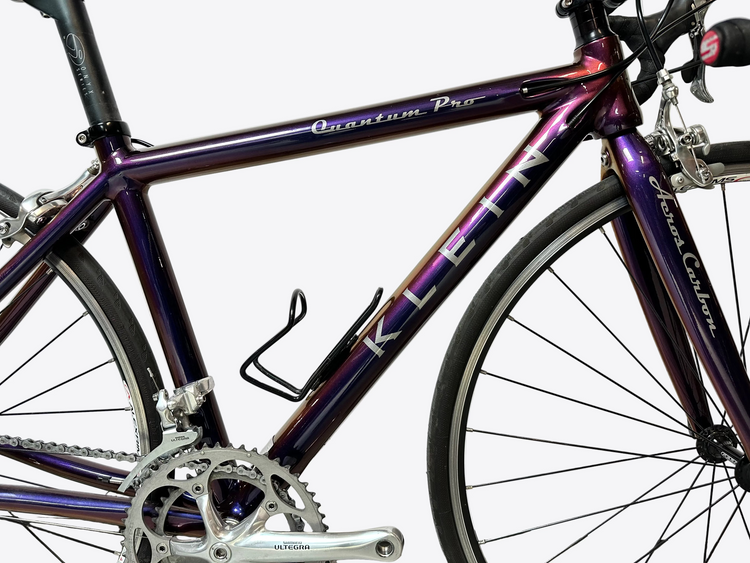 Purple bicycle with 'Quantum Pro' branding on a white background