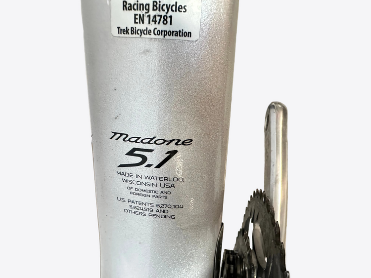 Close-up of a bicycle frame with 'Madone 5.1' branding and Trek Bicycle Corporation label.