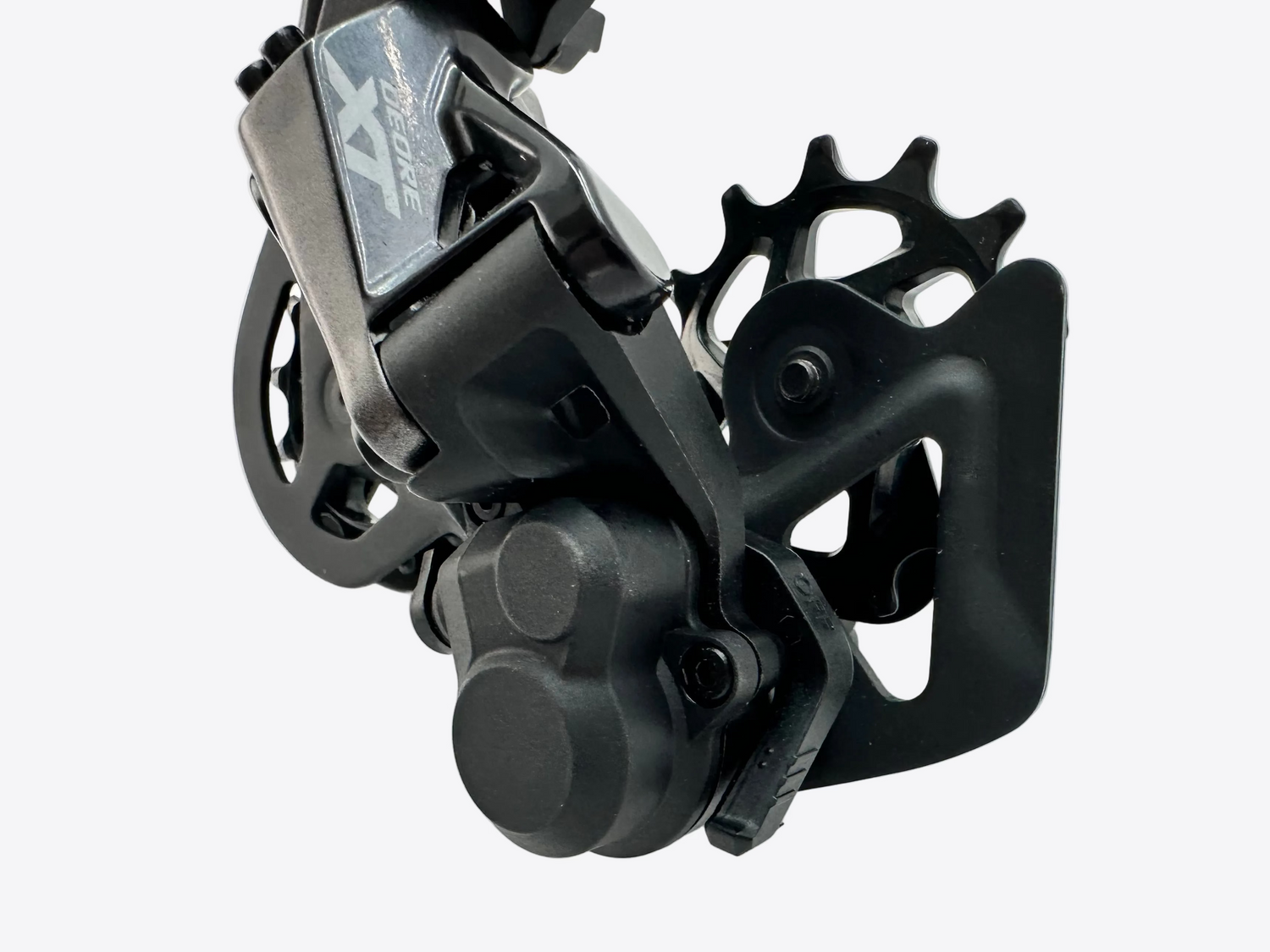 Close-up of a black bicycle gear mechanism on a white background