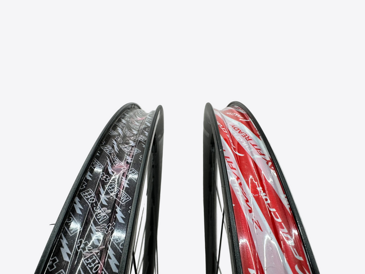Two bicycle wheels with different designs on a white background