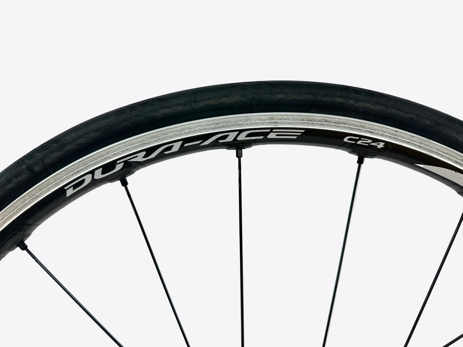 Close-up of a bicycle wheel with 'Durace' branding on a white background