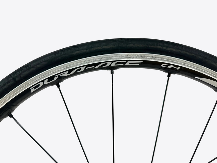 Close-up of a bicycle wheel with 'Durace' branding on a white background