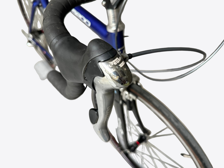 Close-up of bicycle handlebars with visible brand logos on a blurred background