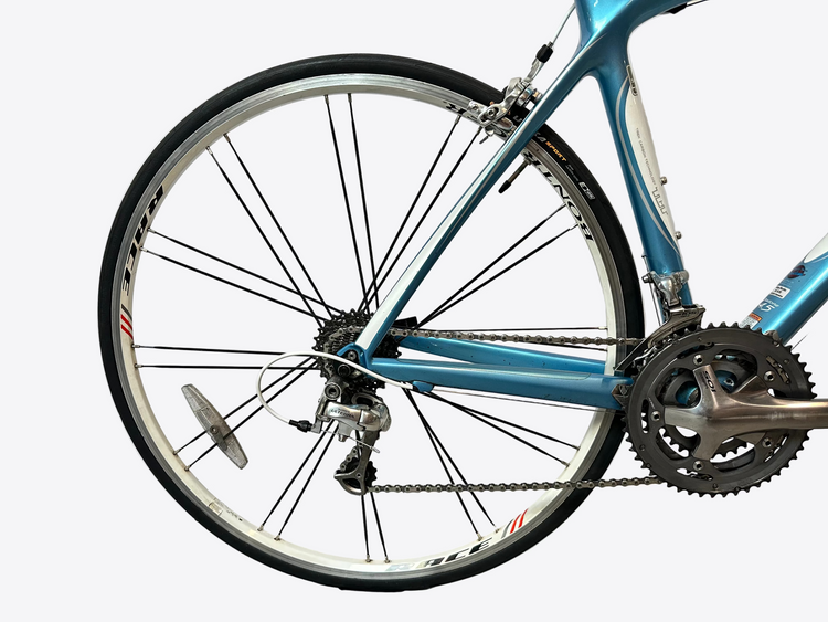 Close-up of a blue bicycle wheel and frame against a white background