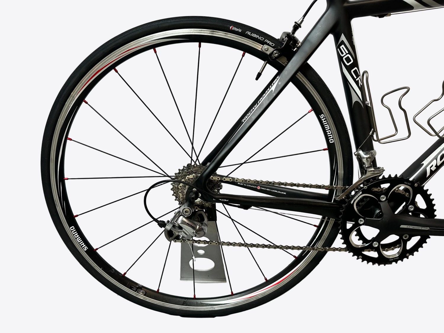 Close-up of a bicycle wheel and frame on a white background