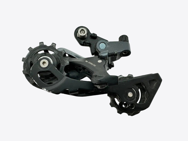 Black bicycle gear mechanism on a light gray background