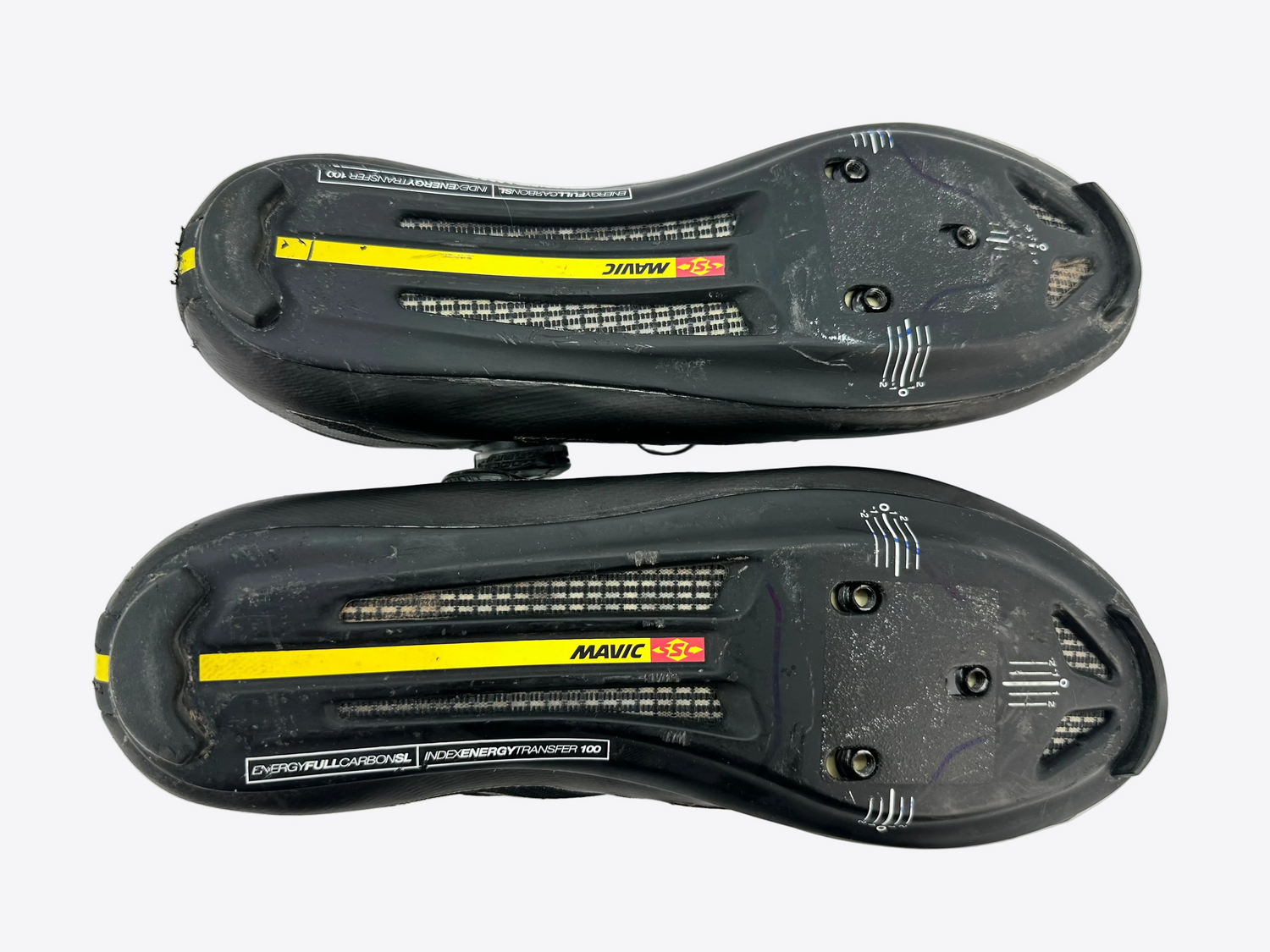 A pair of black Mavic cycling shoes shown from the bottom, displaying the cleat interface, vented panels, and Mavic branding on a white background.