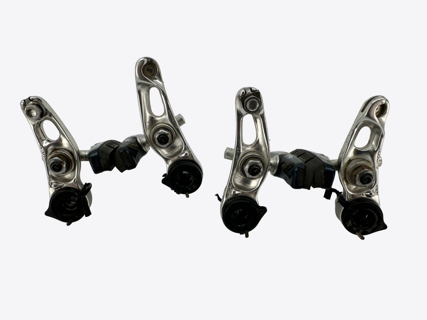 Two metal bicycle derailleurs on a white background