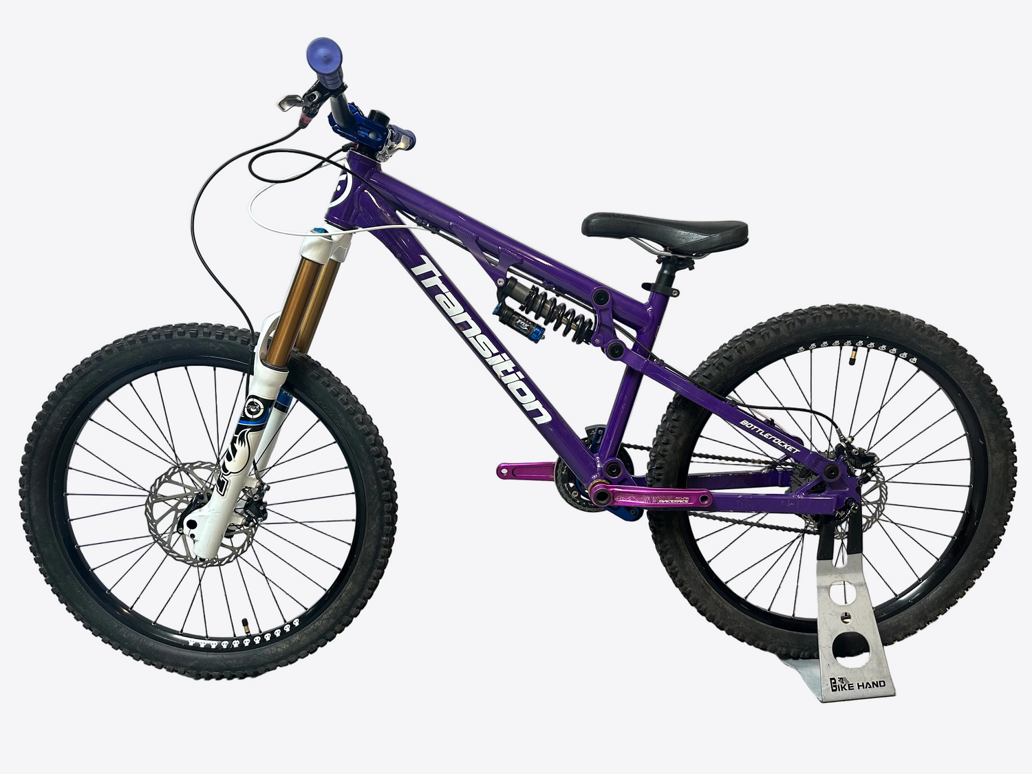 Purple bicycle with visible branding on a white background