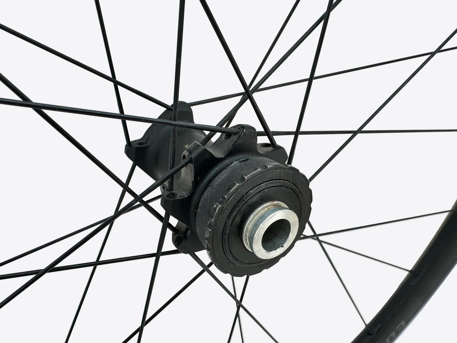 Close-up of a bicycle hub with spokes against a white background