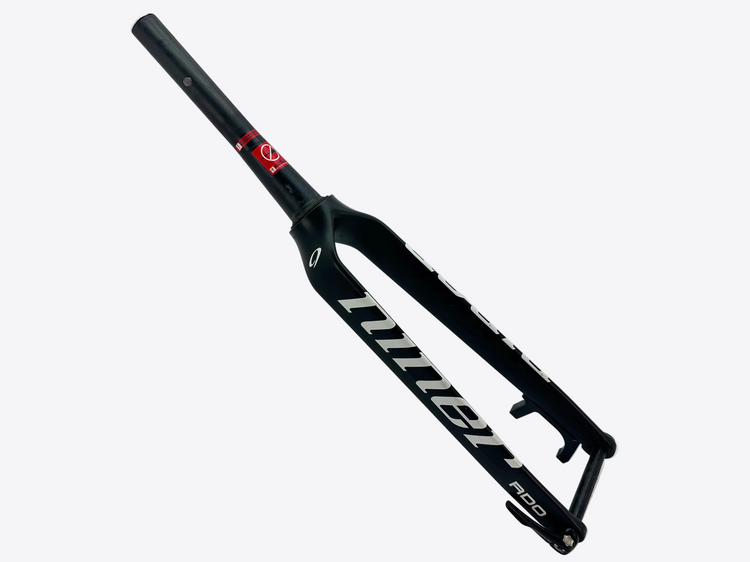 Black bicycle fork with white branding on a light gray background