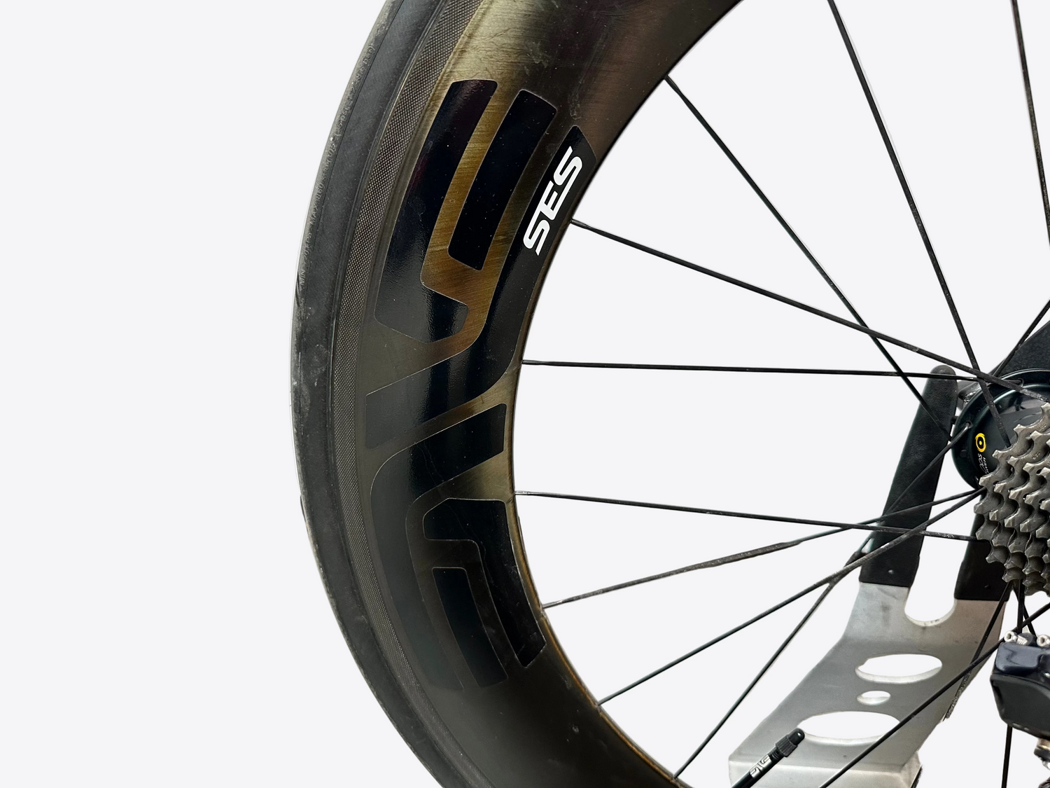 Close-up of a bicycle wheel with 'SES' branding on a blurred background