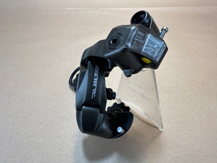 Black metal derailleur on a beige background