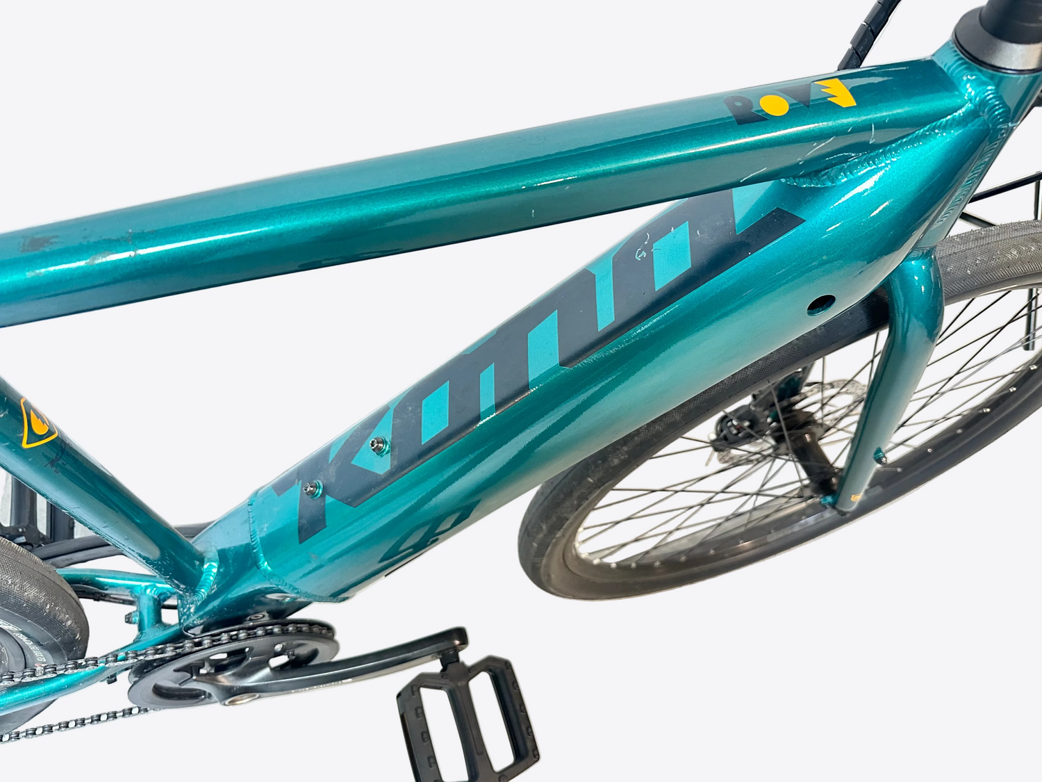 Teal bicycle frame with 'Kona' branding on a light background