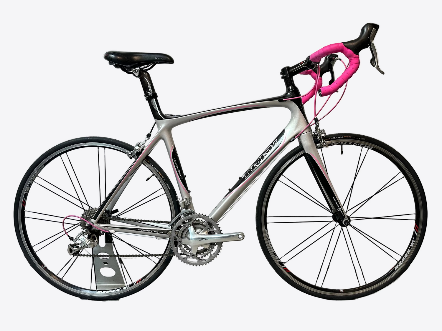 Silver bicycle with pink handlebars on a white background
