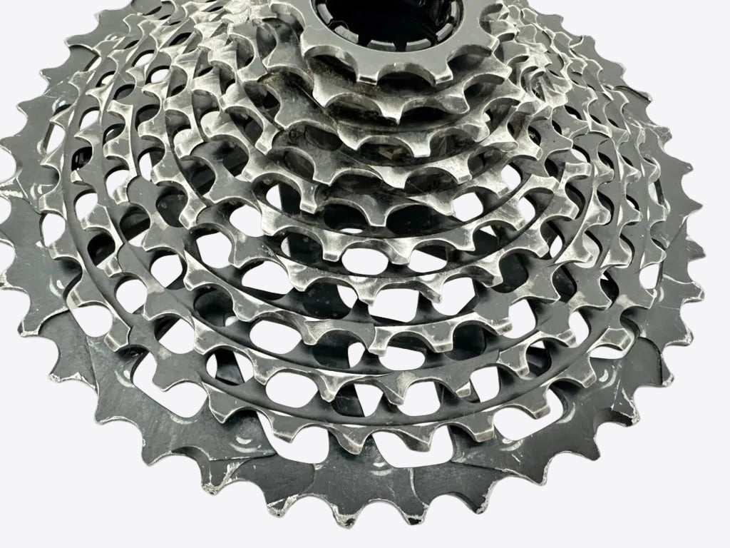 Close-up of a bicycle gear cassette on a white background