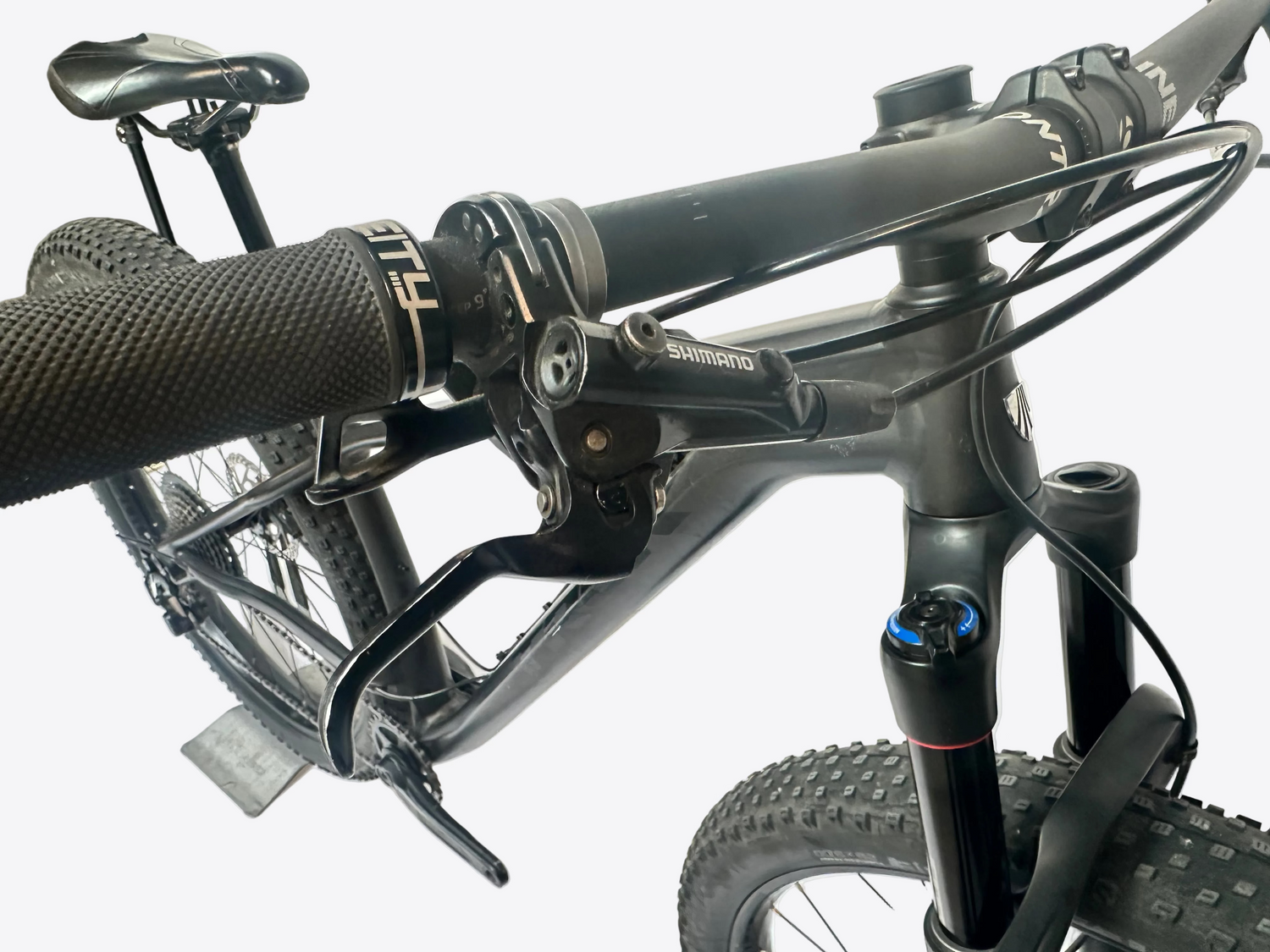 Close-up of a bicycle handlebar with visible brand logos on a white background