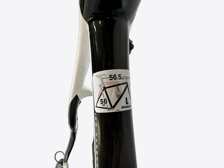 Close-up of a bicycle frame with a label in an indoor setting