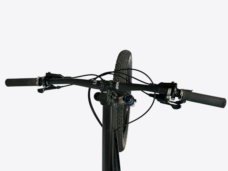 Close-up of a bicycle handlebar with visible brand logos on a white stand.