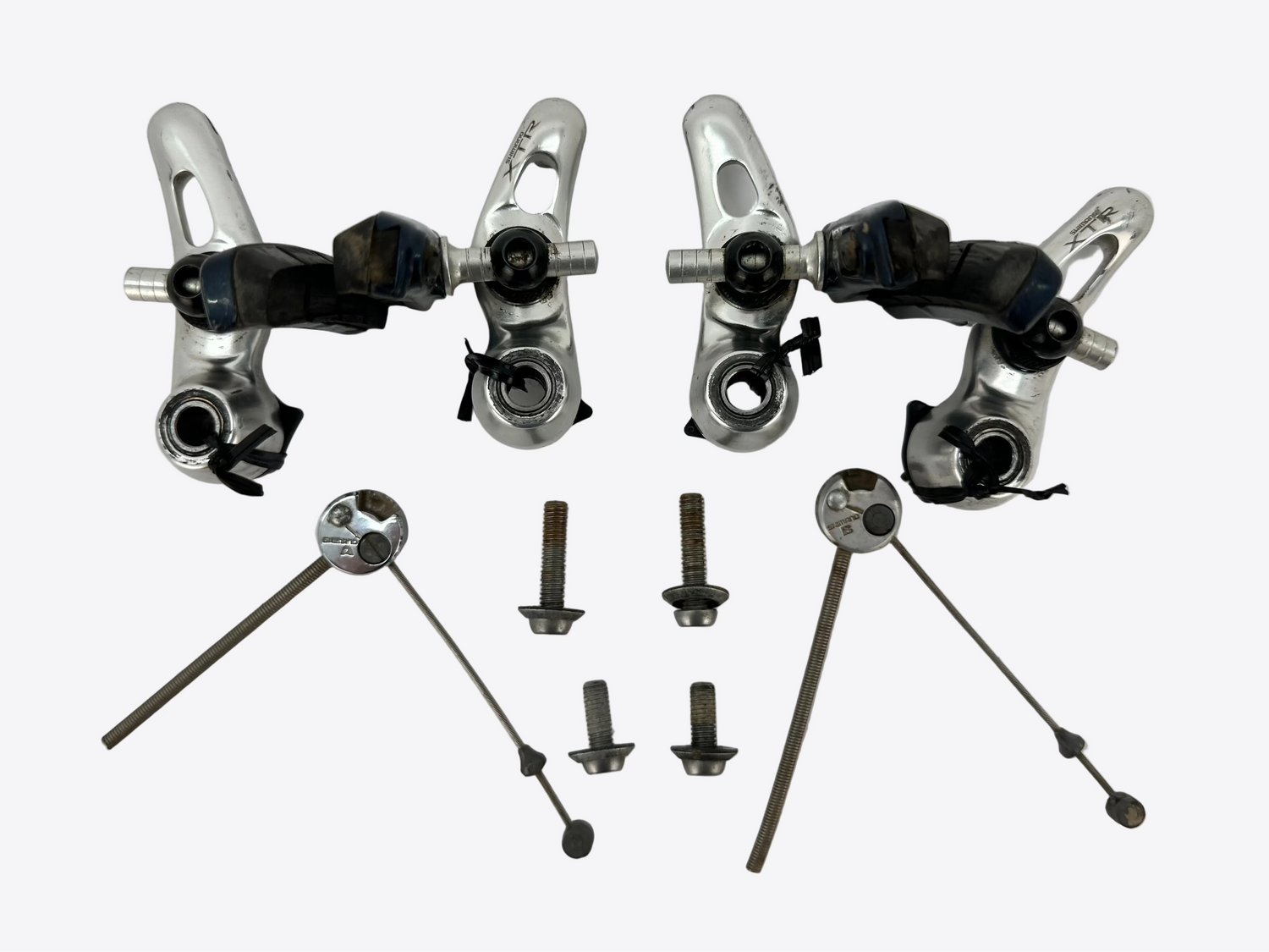 Set of bicycle brake calipers and components on a white background