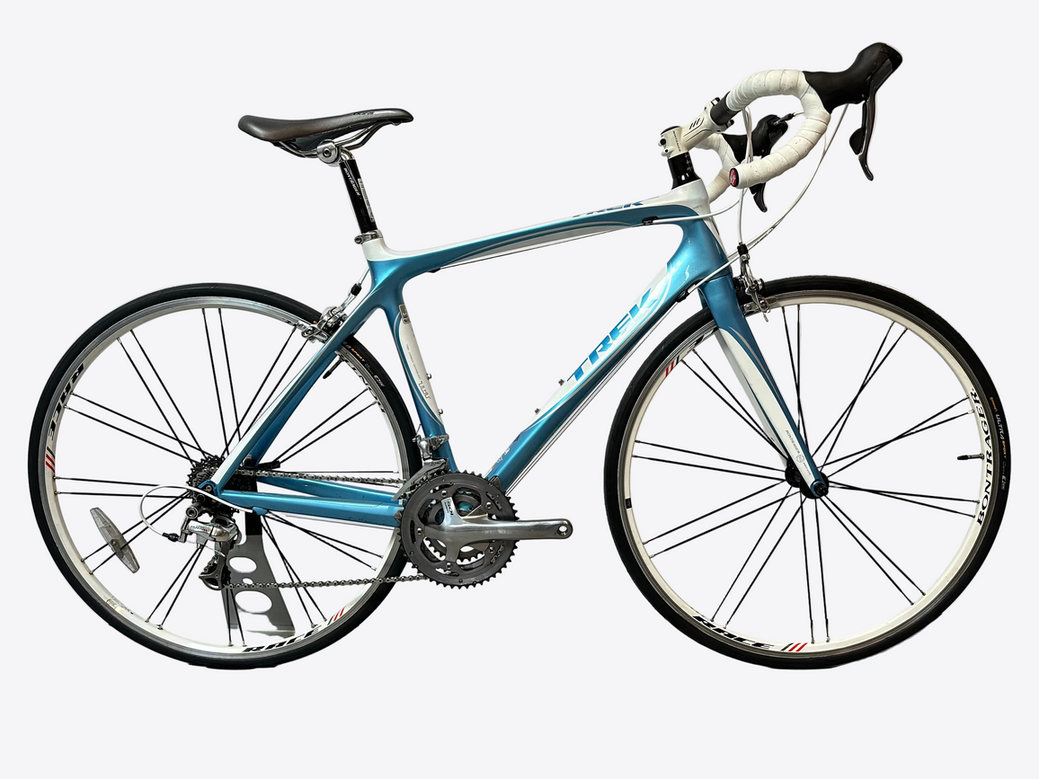 Blue bicycle on a stand against a white background