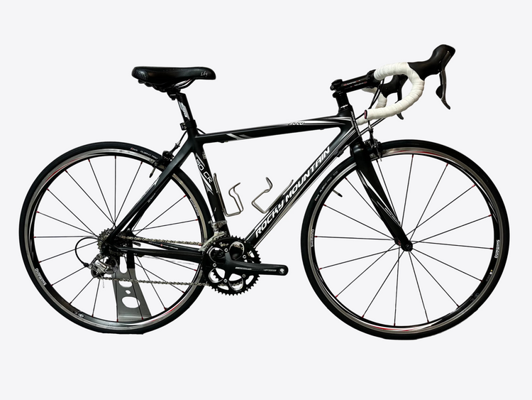 Black bicycle on a gray floor with a white wall background