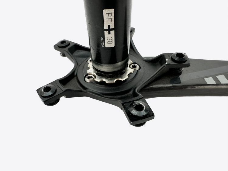 Close-up of a bicycle crankset on a white background