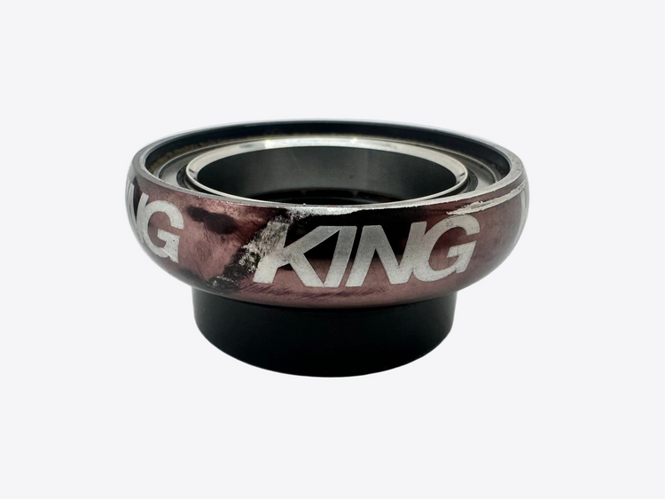 Two King brand bearings stacked on a white background