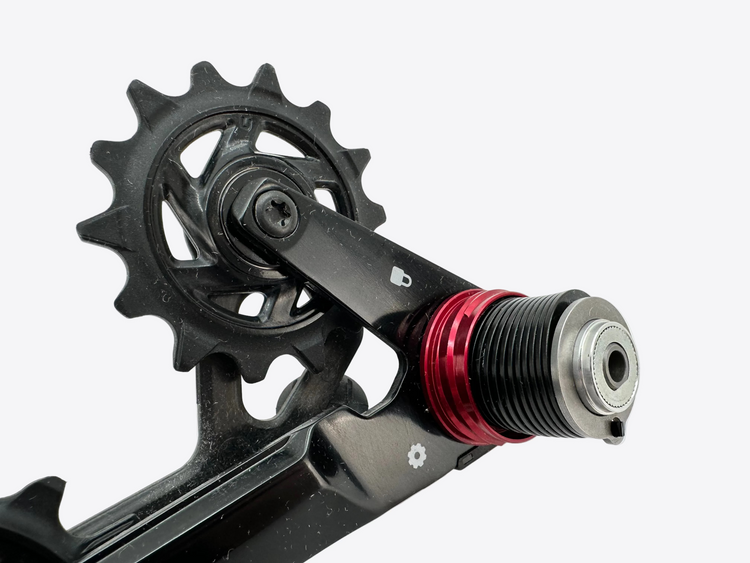Close-up of a bicycle crankset with a red毅扣 on a white background