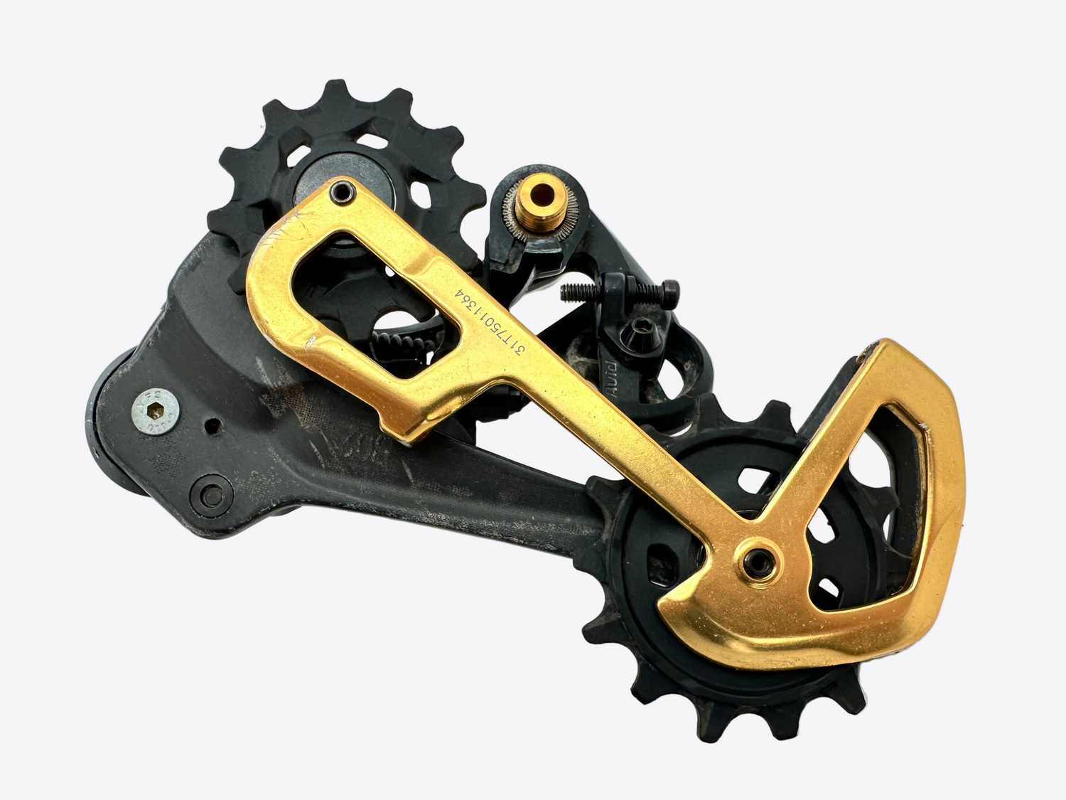 Bicycle gear mechanism with gold and black components on a white background