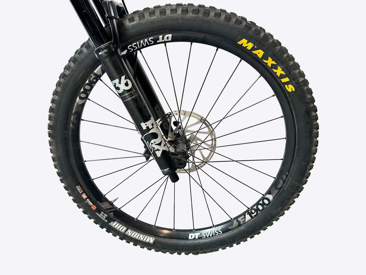 Close-up of a bicycle wheel with 'Maxxis' and 'DT Swiss' branding on a white background