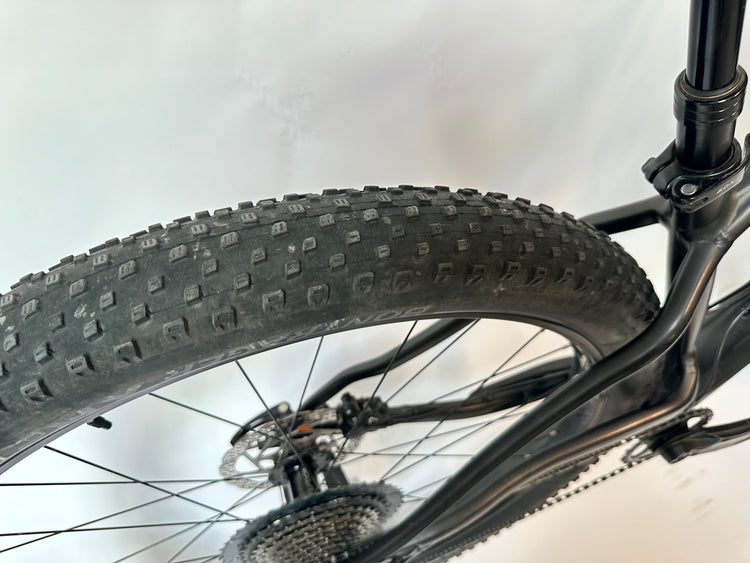 Close-up of a bicycle tire with tread pattern on a white background