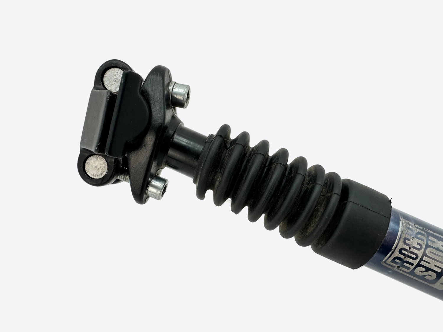 Close-up of a shock absorber with visible branding on a white background