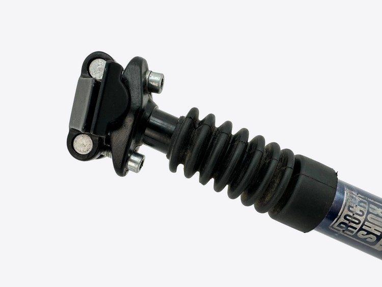 Close-up of a shock absorber with visible branding on a white background