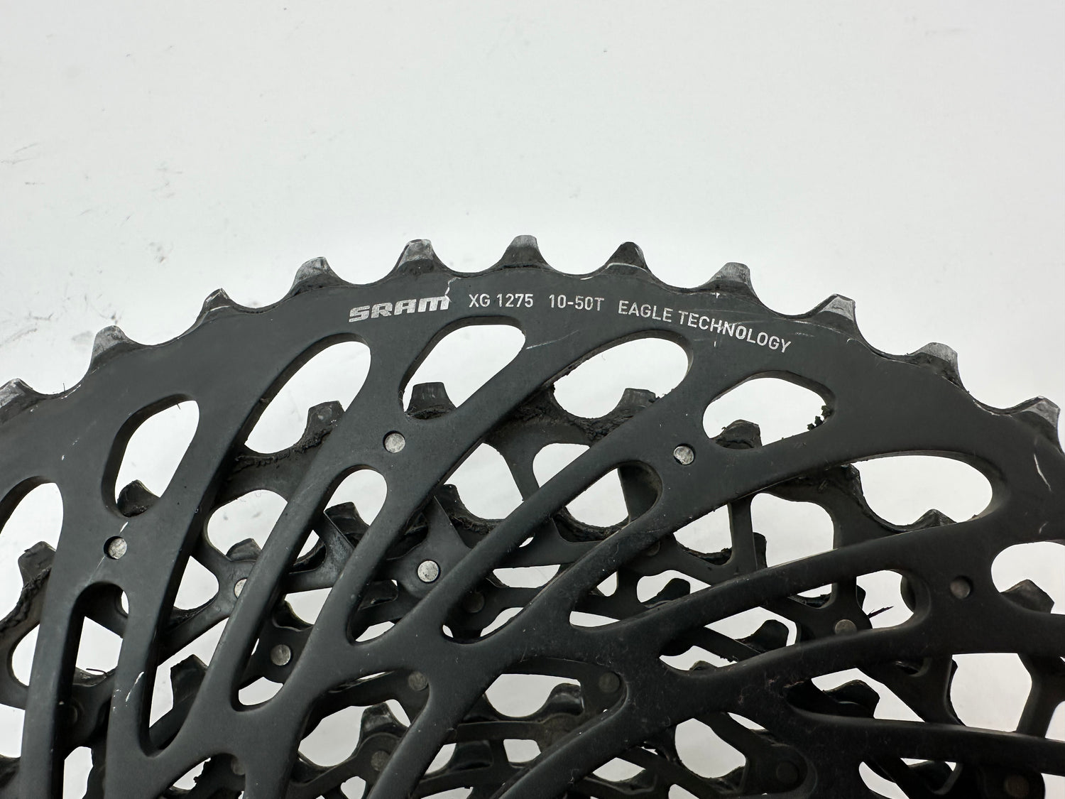 Close-up of a SRAM bicycle chainring on a white background