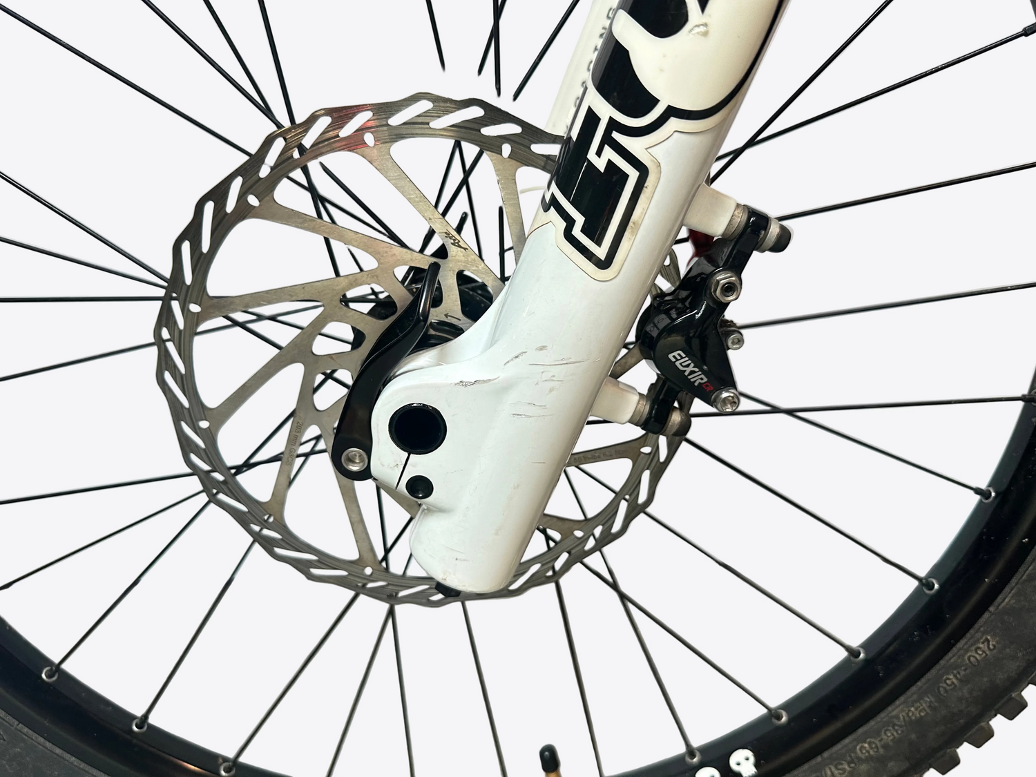 Close-up of a bicycle wheel with disc brake system on a white background